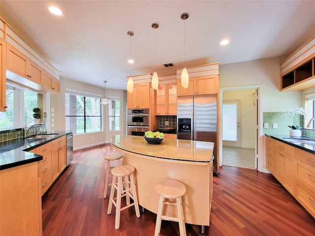4900 Willow St, Bellaire, TX 77401 - kitchen with appliances with stainless steel finishes, light brown cabinetry, a sink, backsplash, and recessed lighting