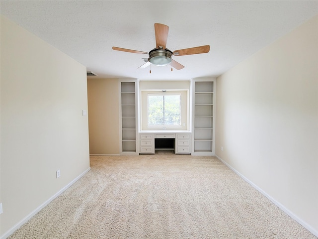 4900 Willow St, Bellaire, TX 77401 - unfurnished living room featuring baseboards, built in features, light colored carpet, and a ceiling fan