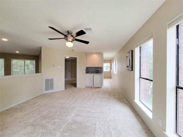 4900 Willow St, Bellaire, TX 77401 - unfurnished living room with light carpet, baseboards, ceiling fan, and recessed lighting