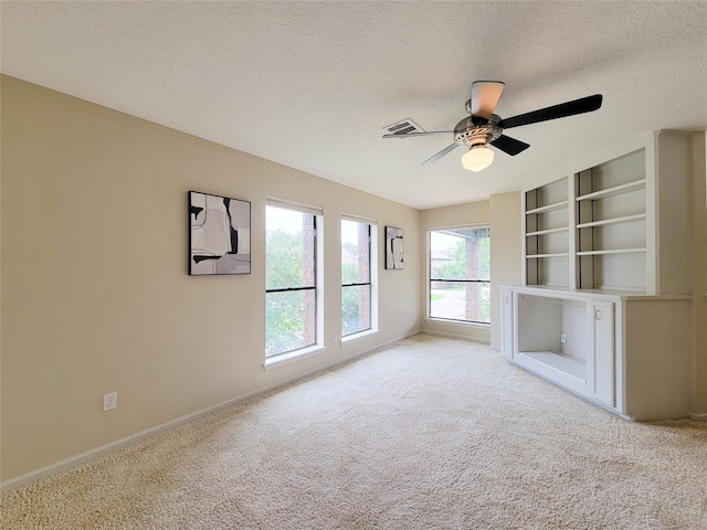 4900 Willow St, Bellaire, TX 77401 - unfurnished living room with a textured ceiling, light carpet, baseboards, and a ceiling fan