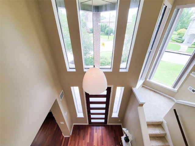 4900 Willow St, Bellaire, TX 77401 - entryway featuring wood finished floors, a high ceiling, and stairway