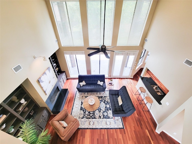 4900 Willow St, Bellaire, TX 77401 - living area featuring wood finished floors, a towering ceiling, and a ceiling fan