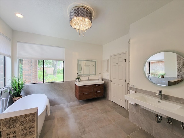4900 Willow St, Bellaire, TX 77401 - full bathroom featuring a freestanding bath, a chandelier, and a sink