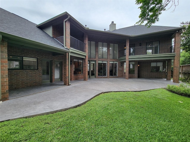 4900 Willow St, Bellaire, TX 77401 - back of property featuring a balcony, brick siding, a lawn, a patio, and a chimney