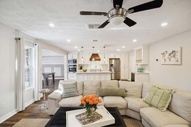 11102 Hillcroft St, Houston, TX 77096 - living area with dark wood finished floors, baseboards, recessed lighting, a ceiling fan, and a textured ceiling