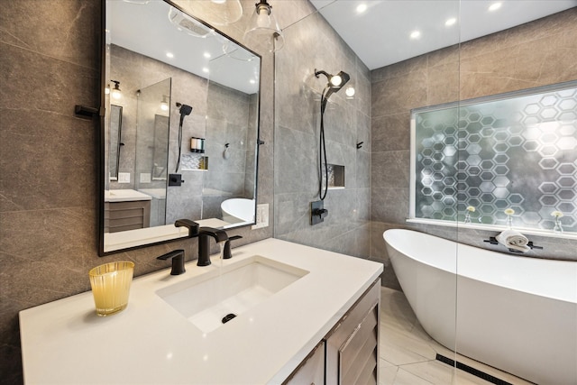 11102 Hillcroft St, Houston, TX 77096 - bathroom featuring tile walls, a freestanding bath, vanity, walk in shower, and recessed lighting