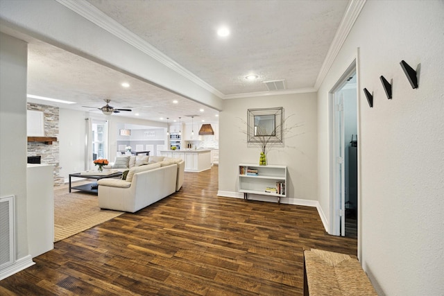 11102 Hillcroft St, Houston, TX 77096 - living area with a fireplace, wood finished floors, ornamental molding, a ceiling fan, and baseboards