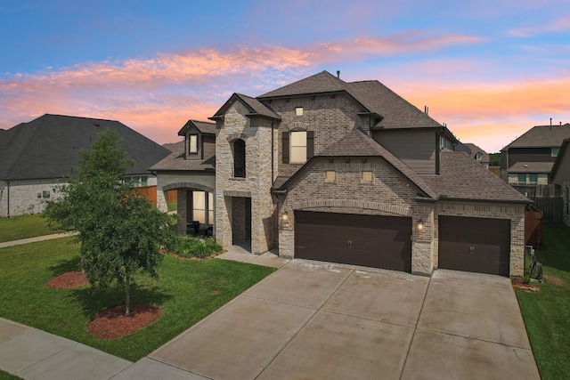 3403 Majestic Pine Ln, Rosenberg, TX 77471 - french country inspired facade featuring stone siding, a yard, roof with shingles, and driveway