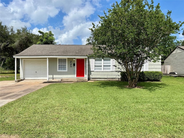 225 Laurel St, Lake Jackson, TX 77566 - view of front of home featuring a garage, a front lawn, and concrete driveway