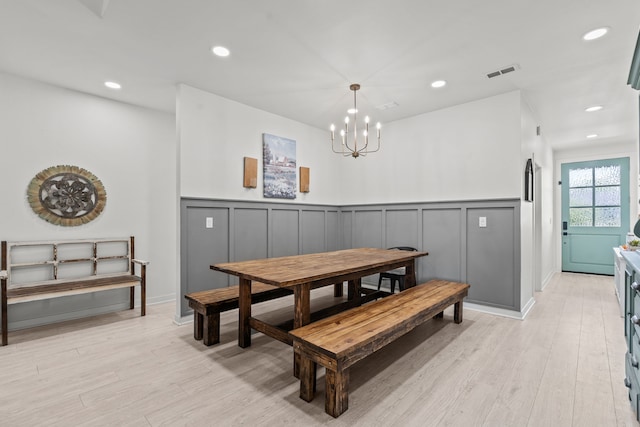 50 Berry St, Coldspring, TX 77331 - dining space with a decorative wall, light wood-style flooring, a chandelier, a wainscoted wall, and recessed lighting