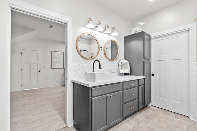 50 Berry St, Coldspring, TX 77331 - bathroom featuring backsplash, vanity, and wood finished floors