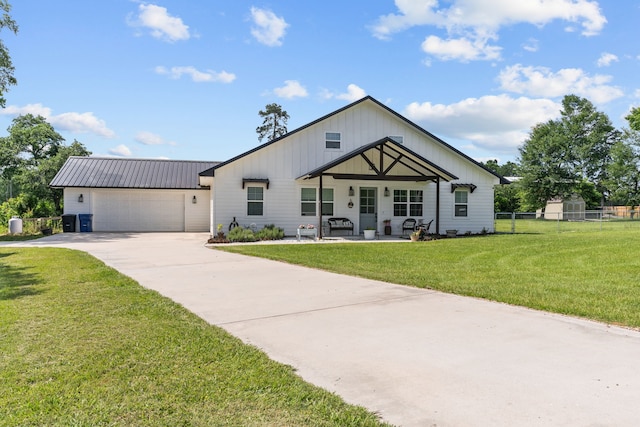 50 Berry St, Coldspring, TX 77331 - modern farmhouse featuring concrete driveway, a garage, and metal roof