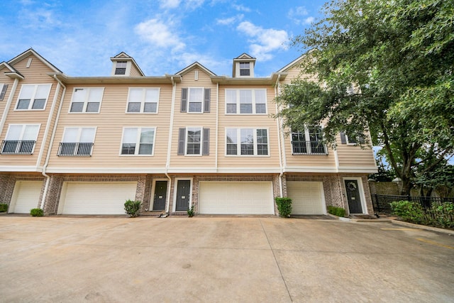 3001 Murworth Dr Unit 103, Houston, TX 77025 - townhome / multi-family property with an attached garage, driveway, and brick siding