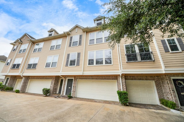 3001 Murworth Dr Unit 103, Houston, TX 77025 - view of property featuring an attached garage, brick siding, and driveway