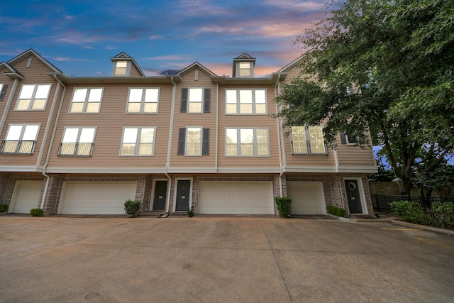 3001 Murworth Dr Unit 103, Houston, TX 77025 - view of property with a garage, driveway, and brick siding
