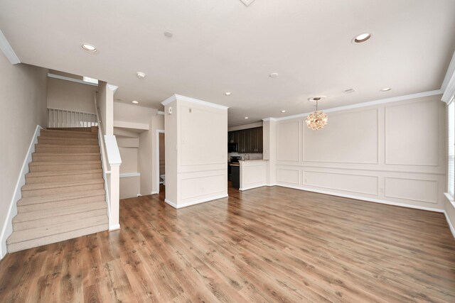 3001 Murworth Dr Unit 103, Houston, TX 77025 - unfurnished living room with stairway, light wood-style flooring, a chandelier, a decorative wall, and recessed lighting