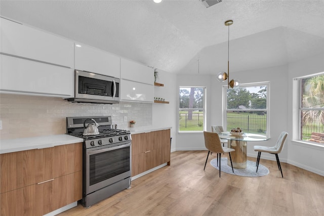 18327 Marlin Waters Dr, Humble, TX 77346 - kitchen featuring stainless steel appliances, modern cabinets, backsplash, light wood-type flooring, and open shelves
