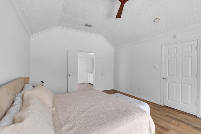 18327 Marlin Waters Dr, Humble, TX 77346 - bedroom with ornamental molding, vaulted ceiling, a textured ceiling, wood finished floors, and a ceiling fan