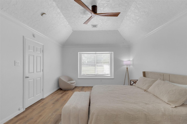 18327 Marlin Waters Dr, Humble, TX 77346 - bedroom featuring wood finished floors, ornamental molding, lofted ceiling, a textured ceiling, and baseboards