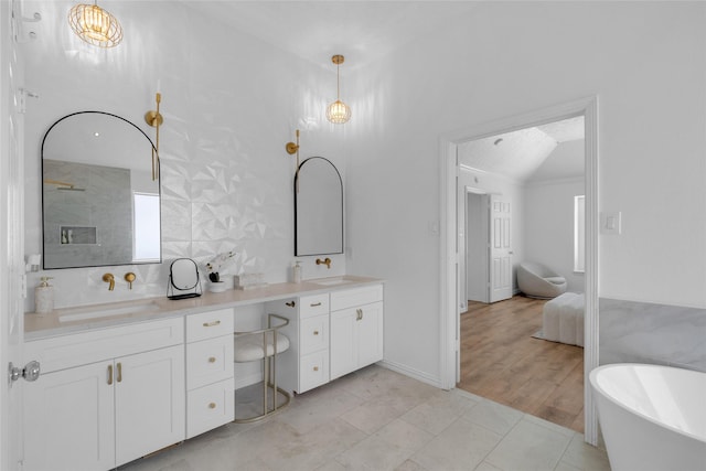 18327 Marlin Waters Dr, Humble, TX 77346 - full bathroom with double vanity, a freestanding bath, and vaulted ceiling