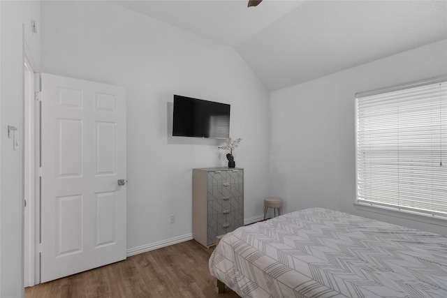 18327 Marlin Waters Dr, Humble, TX 77346 - bedroom with wood finished floors, lofted ceiling, baseboards, and a ceiling fan