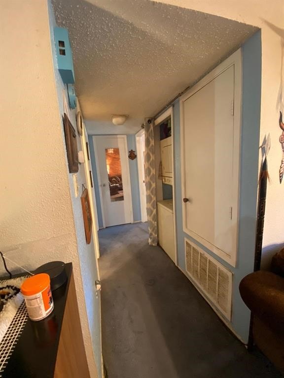 10049 Westpark Dr Unit 136, Houston, TX 77042 - corridor with a textured ceiling and carpet