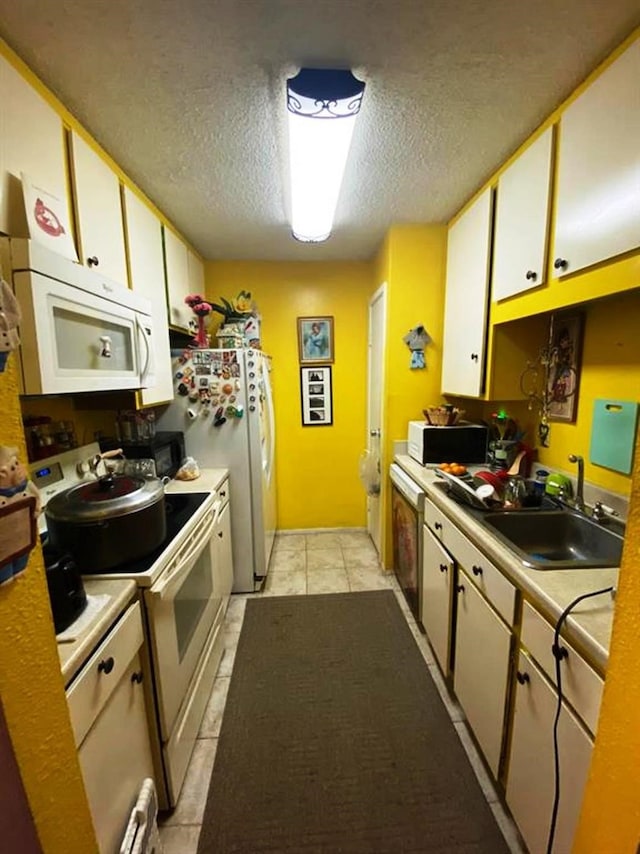10049 Westpark Dr Unit 136, Houston, TX 77042 - kitchen featuring white appliances, a sink, a textured ceiling, light countertops, and light tile patterned flooring