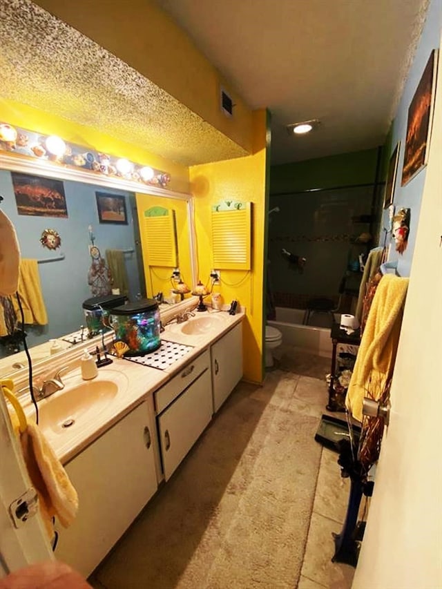10049 Westpark Dr Unit 136, Houston, TX 77042 - bathroom featuring double vanity, toilet, washtub / shower combination, and tile patterned flooring
