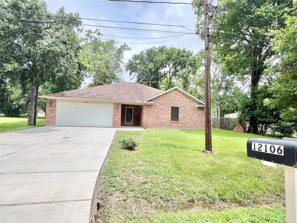 12106 24th St, Santa Fe, TX 77510 - single story home with brick siding, concrete driveway, and a garage