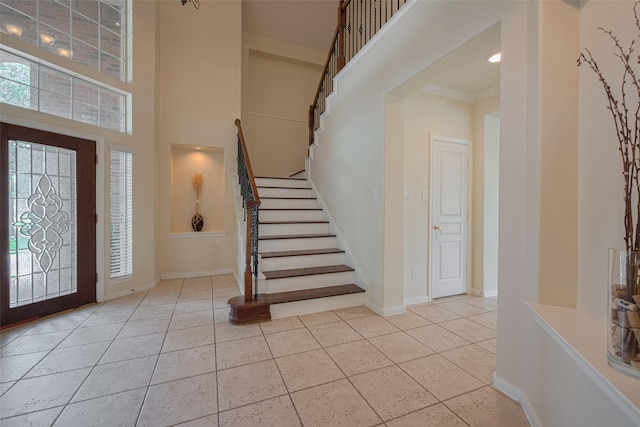 4515 Tremont Glen Ln, Katy, TX 77494 - tiled foyer entrance with stairway, a high ceiling, baseboards, and ornamental molding