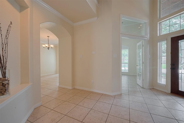 4515 Tremont Glen Ln, Katy, TX 77494 - entrance foyer with arched walkways, ornamental molding, light tile patterned flooring, a chandelier, and baseboards