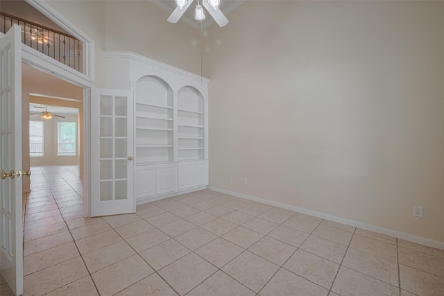 4515 Tremont Glen Ln, Katy, TX 77494 - empty room featuring ceiling fan, light tile patterned flooring, french doors, and a high ceiling