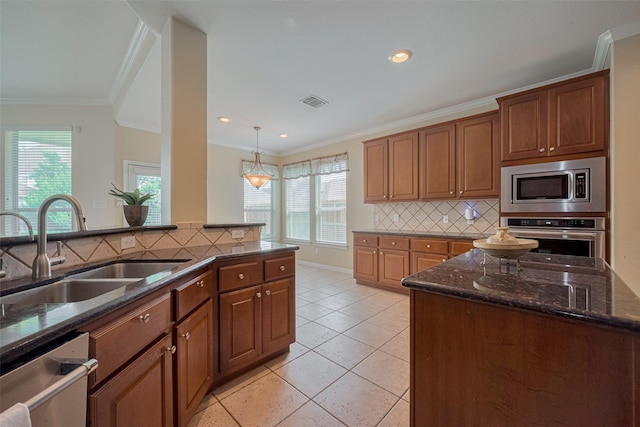 4515 Tremont Glen Ln, Katy, TX 77494 - kitchen with stainless steel appliances, a sink, dark stone countertops, tasteful backsplash, and crown molding