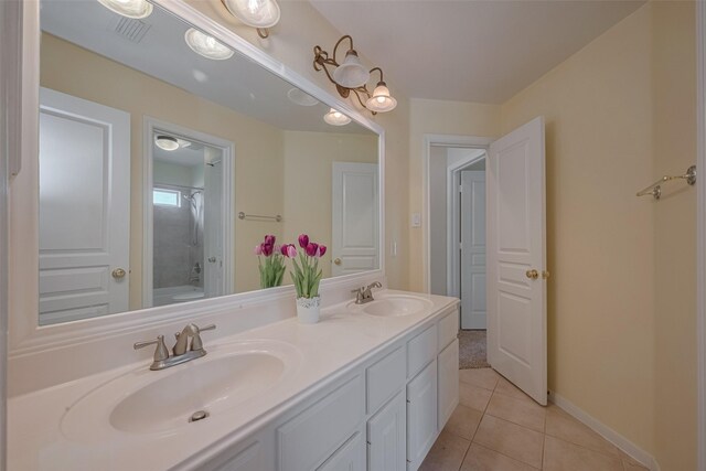 4515 Tremont Glen Ln, Katy, TX 77494 - bathroom featuring double vanity, tile patterned flooring, shower / bathtub combination, and baseboards