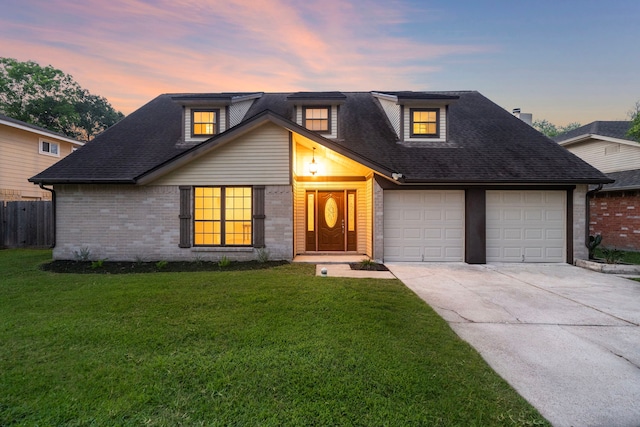 2311 Jackson Ln, League City, TX 77573 - view of front of home featuring an attached garage, driveway, brick siding, and roof with shingles