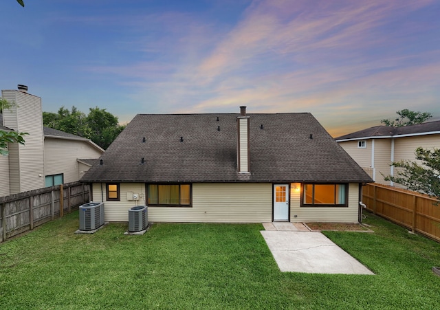 2311 Jackson Ln, League City, TX 77573 - rear view of property featuring central air condition unit, roof with shingles, and a patio area