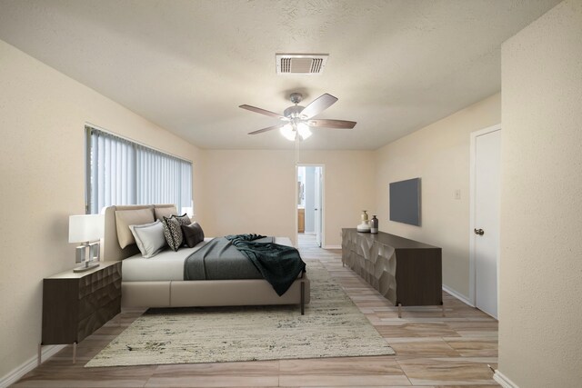 2311 Jackson Ln, League City, TX 77573 - bedroom with baseboards, ceiling fan, light wood-type flooring, and connected bathroom