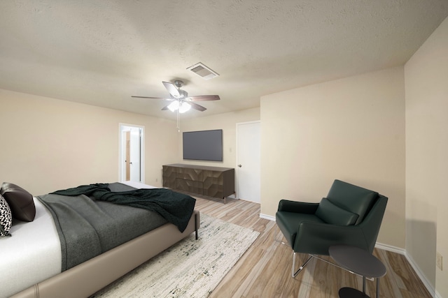 2311 Jackson Ln, League City, TX 77573 - bedroom with light wood-style flooring, a ceiling fan, baseboards, and a textured ceiling