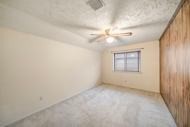 2311 Jackson Ln, League City, TX 77573 - spare room featuring light carpet, ceiling fan, wooden walls, and a textured ceiling