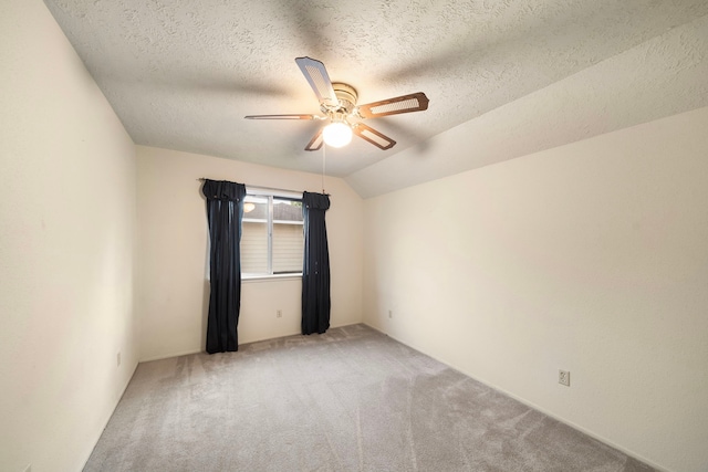 2311 Jackson Ln, League City, TX 77573 - empty room featuring a ceiling fan, light carpet, a textured ceiling, and vaulted ceiling