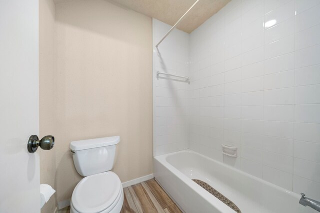 2311 Jackson Ln, League City, TX 77573 - full bathroom featuring toilet, baseboards, wood finished floors, and shower / washtub combination