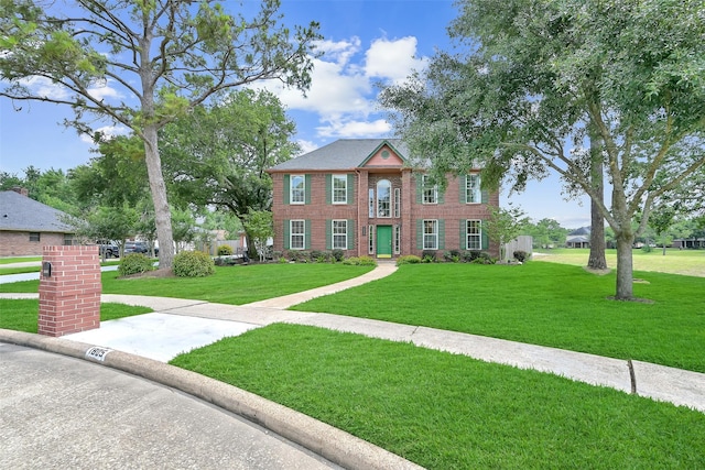 1805 Twin Oaks St, Friendswood, TX 77546 - colonial-style house featuring a front lawn and brick siding