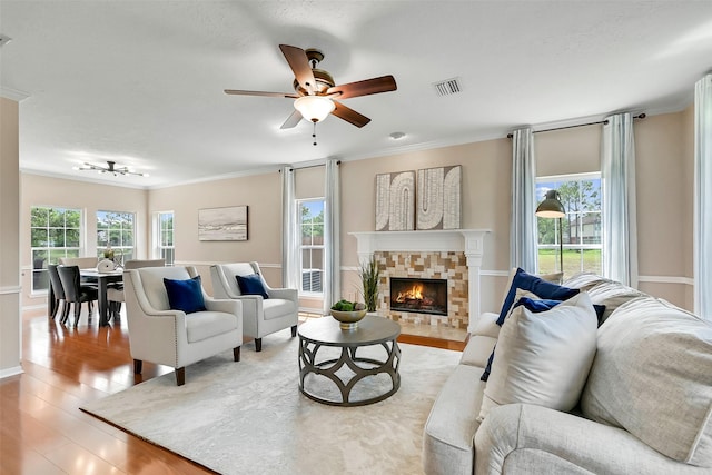 1805 Twin Oaks St, Friendswood, TX 77546 - living room with wood finished floors, crown molding, ceiling fan, a fireplace, and baseboards
