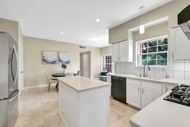 1805 Twin Oaks St, Friendswood, TX 77546 - kitchen with black appliances, a center island, decorative backsplash, a sink, and light countertops