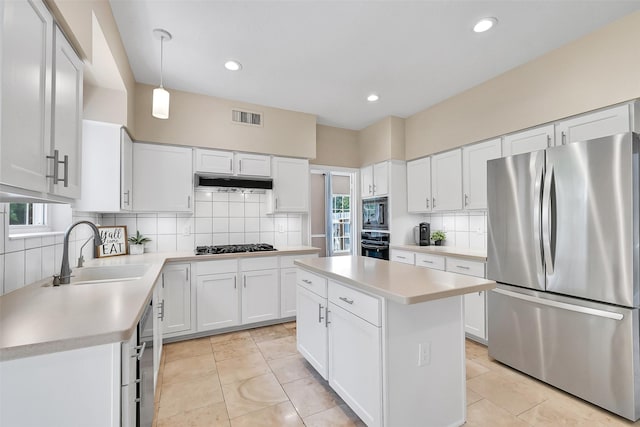 1805 Twin Oaks St, Friendswood, TX 77546 - kitchen with black appliances, a sink, light countertops, backsplash, and recessed lighting