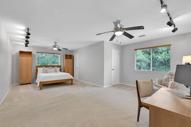 1805 Twin Oaks St, Friendswood, TX 77546 - bedroom with rail lighting, baseboards, light colored carpet, and a ceiling fan