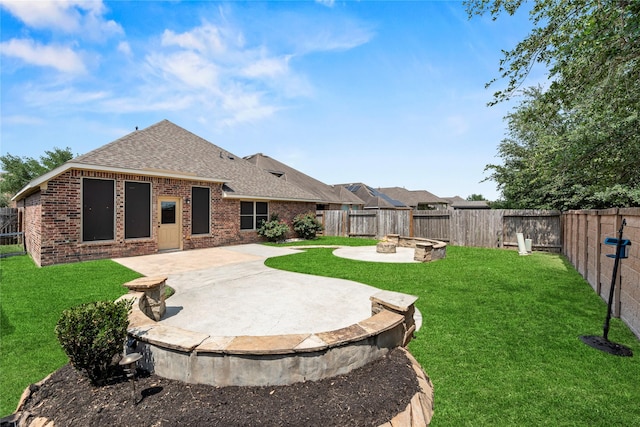 24747 Ballad Dr, Katy, TX 77493 - rear view of property with roof with shingles, brick siding, a patio area, and an outdoor fire pit