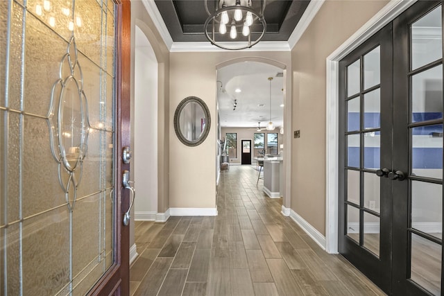 24747 Ballad Dr, Katy, TX 77493 - foyer featuring arched walkways, a chandelier, french doors, baseboards, and crown molding