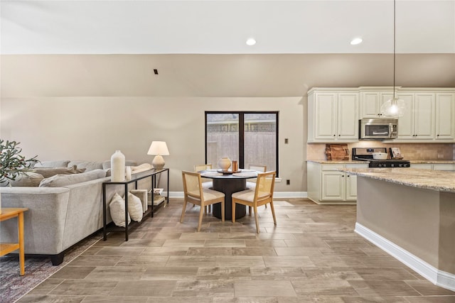 24747 Ballad Dr, Katy, TX 77493 - kitchen featuring stainless steel appliances, decorative light fixtures, light wood-style flooring, baseboards, and recessed lighting