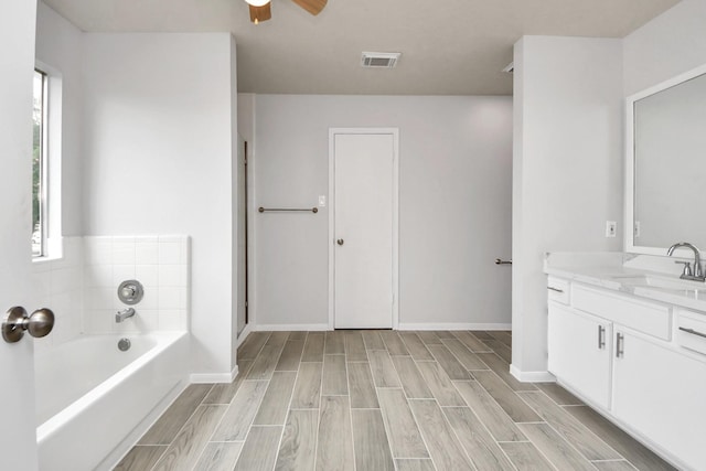 4310 Lucas Trace Ct, Houston, TX 77066 - full bath featuring vanity, a bath, wood tiled floors, and healthy amount of natural light